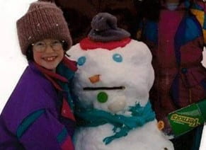 The author as a young girl with a snowman.